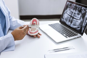 Dentist examining a patient teeth medical treatment at the dental clinic.