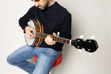 young man playing banjo on the white background
