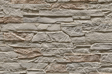 beige stone wall, stone texture. decorative tiles for wall decoration. Background, beige decorative brick. loft decor style. structural surface imitating old brick. Slate Stone wall brown texture.