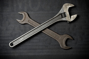 Open-ended and adjustable wrench on a dark background. Renovation concept.