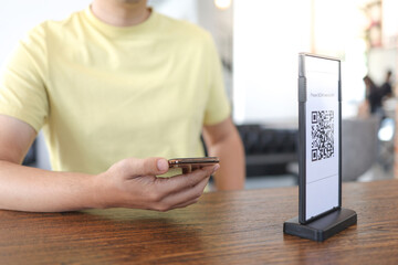 Qr code payment. E wallet. Man scanning tag accepted generate digital pay without money.scanning QR code online shopping cashless payment and verification.technology concept
