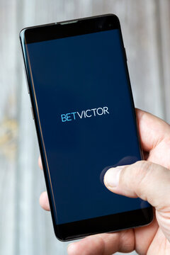02-24-2021 Portsmouth, Hampshire, UK A mobile phone or cell phone being held by a hand with the Bet Victor app open on screen