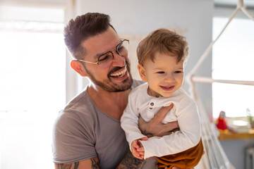 Father looking after his small son at home
