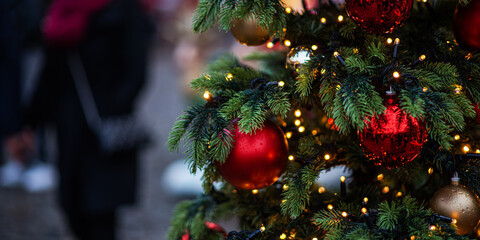 Decorated Christmas tree on blurred background. New Year's and Christmas holiday background with lights on tree.