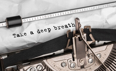 Text Take a deep breath typed on retro typewriter