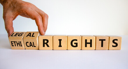 Ethical or legal rights symbol. Businessman turns wooden cubes and changes words ethical rights to legal rights on a beautiful white background. Business, ethical or legal rights concept. Copy space.