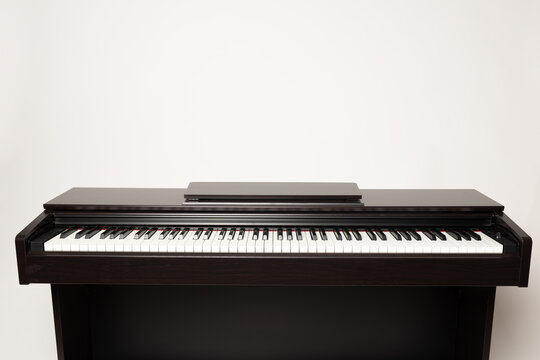 Young Man Playing Piano On The White Background