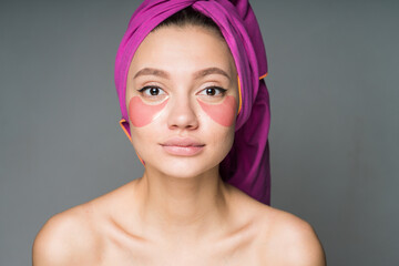 wrapping her head with a tighter girl with hugging shoulders pasted patches under her eyes. High quality photo