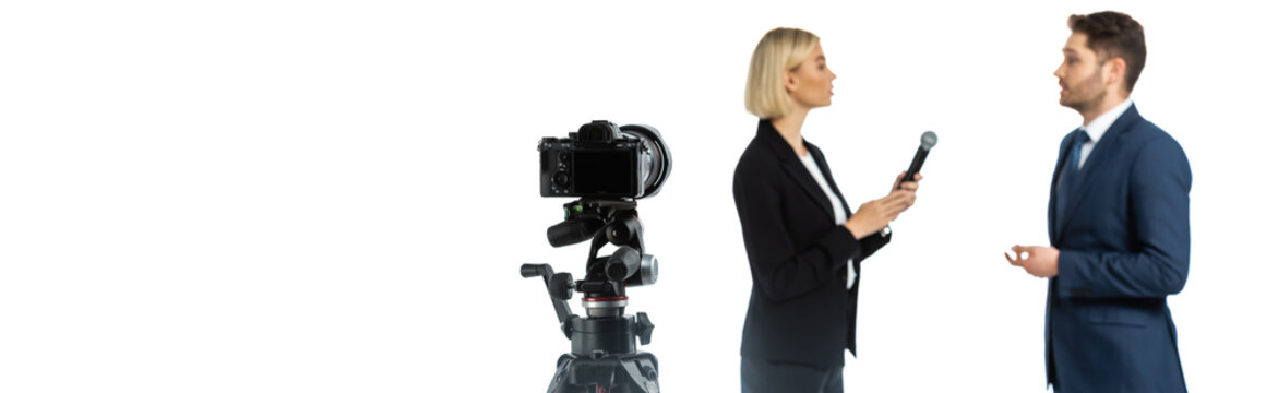 side view of blonde journalist interviewing young businessman isolated on white, blurred background, banner