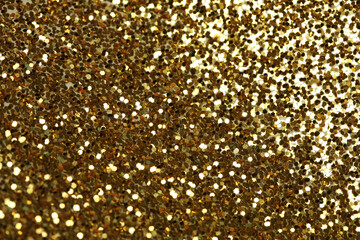 Gold (bronze) glitter shine dots confetti. Abstract light blink sparkle horizontal backgound.