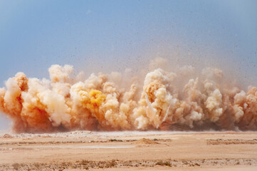 Flying rock and dust clouds during detonator blast on the construction  site 