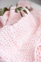soft voluminous luxury pink towel on a white background with a dry branch of eucalyptus
