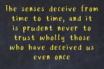 Chalk inscription of smart quote on black desk © iushakovsky