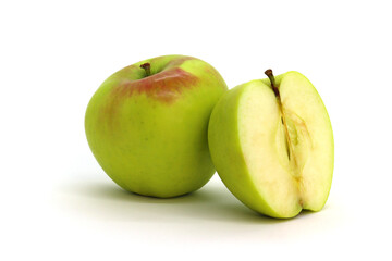 A green apple with a shadow on a white background is isolated