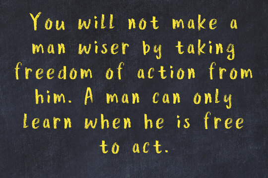 Black chalkboard with wise inscription on it