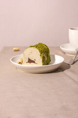 Eastern sweetness - halva with chocolate and pistachios on a table with a hard shadow