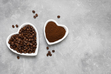 Coffee beans, ground coffee in white plates on a gray background. Top view, copy space.