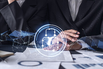 Two businesswomen working on the project to protect cyber security of international company. Padlock Hologram icons over the table with documents.