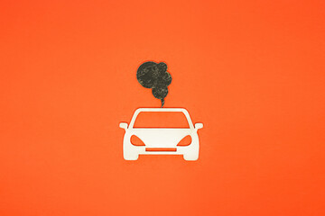 Car and exhaust gases on an orange background. air pollution