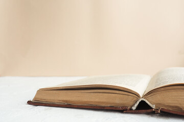 open old book on the table on a beige background..copy space.