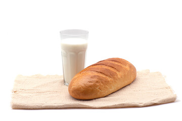 Composition of glass of milk, white bread, tablecloth on white background