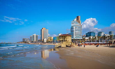 Tel Aviv beach with a view of Mediterranean sea and sea front hotels, Israel. - obrazy, fototapety, plakaty
