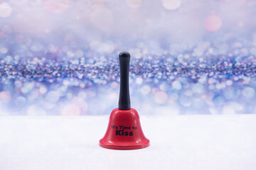 Red bell with inscription It's time to kiss on a festive background