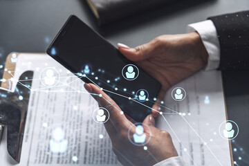 Businesswoman in formal wear checking the phone to sign the employment agreement to boost her career and gain new opportunities in personal growth. Concept of success. Social media hologram icons