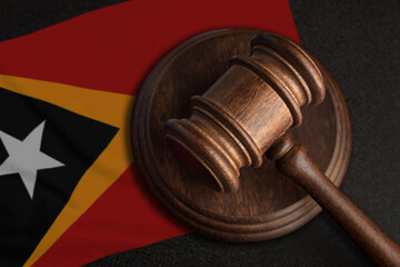 Judge gavel and flag of East Timor. Law and justice in East Timor. Violation of rights and freedoms