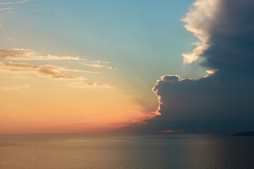 Sun behind the clouds shining on blue sky. Colorful view. Inspiration.