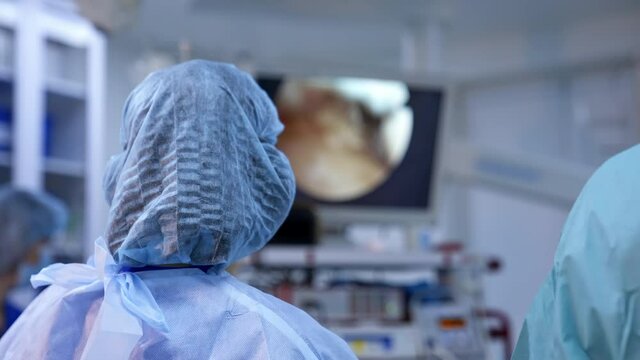 Surgeon working with surgical laparoscopy instruments. Surgeons team preforming operation in hospital operating theater
