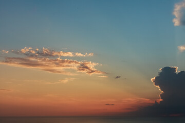 Sun behind the clouds shining on blue sky. Colorful view. Inspiration.