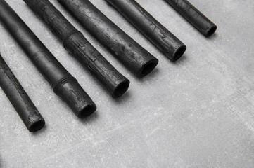Natural activated bamboo charcoal on concrete background. Realistic pieces charcoal.