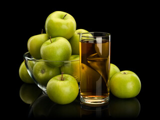 Apple juice and fruits of green apples in glassware