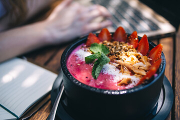 Healthy breakfast bowl. Blueberry smoothie with banana, raspberry, pitaya, blackberry, almonds, sunflower and chia seeds. Healthy food concept.