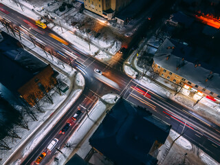 Night aerial view of crossroad with circular cars in small european city