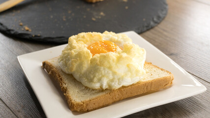 Cloud Eggs. toast with eggs on a dark surface