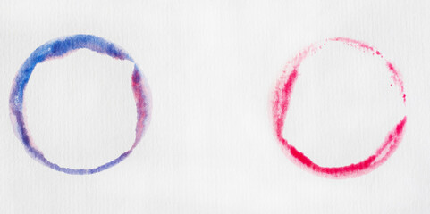 bright pink and blue water colour circles on white paper background