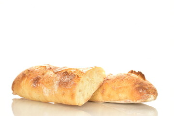 Two delicious freshly baked French baguette halves, close-up, isolated on white.