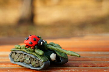 Plasticine tank with ladybug close-up.