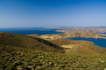Fototapeta na wymiar Landscape of Astypalea island, Greece. At the background there can be seen the narrowest part of the island, a corridor of a few dozens meters that connects the eastern and western part of the island.