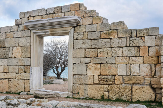 door in the ruins of antique temple by the sea schore