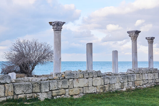 ruins of antique greek temple with columns on the seashore