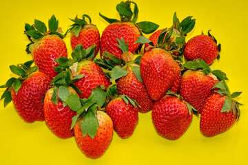 Set of strawberries on a yellow background.