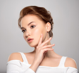 Beautiful face of young caucasian woman with perfect healthy skin, isolated.   Pretty white model caring of face. Beauty treatment concept. Skin care concept.