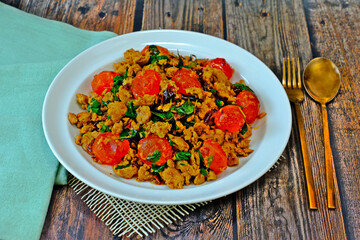 Stir fried spicy minced pork and preserved egg yolk with Thai basil. Authentic Thai food.