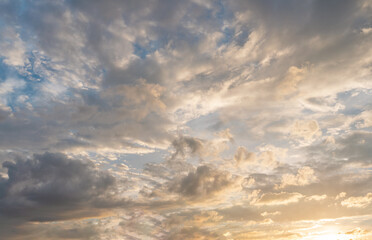 Morning blue orange sky, sun shining through clouds