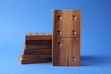 Domino tiles with pips on blue background