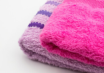 Purple and pink towels for wiping hands and other parts of the body.