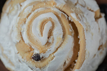 Fried meringue cookie with black raisines and white chocolate on the top